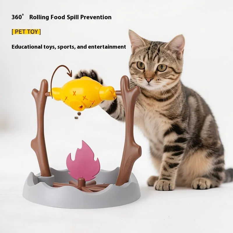 Cat playing with a colourful tumbling puzzle feeder toy that dispenses food.