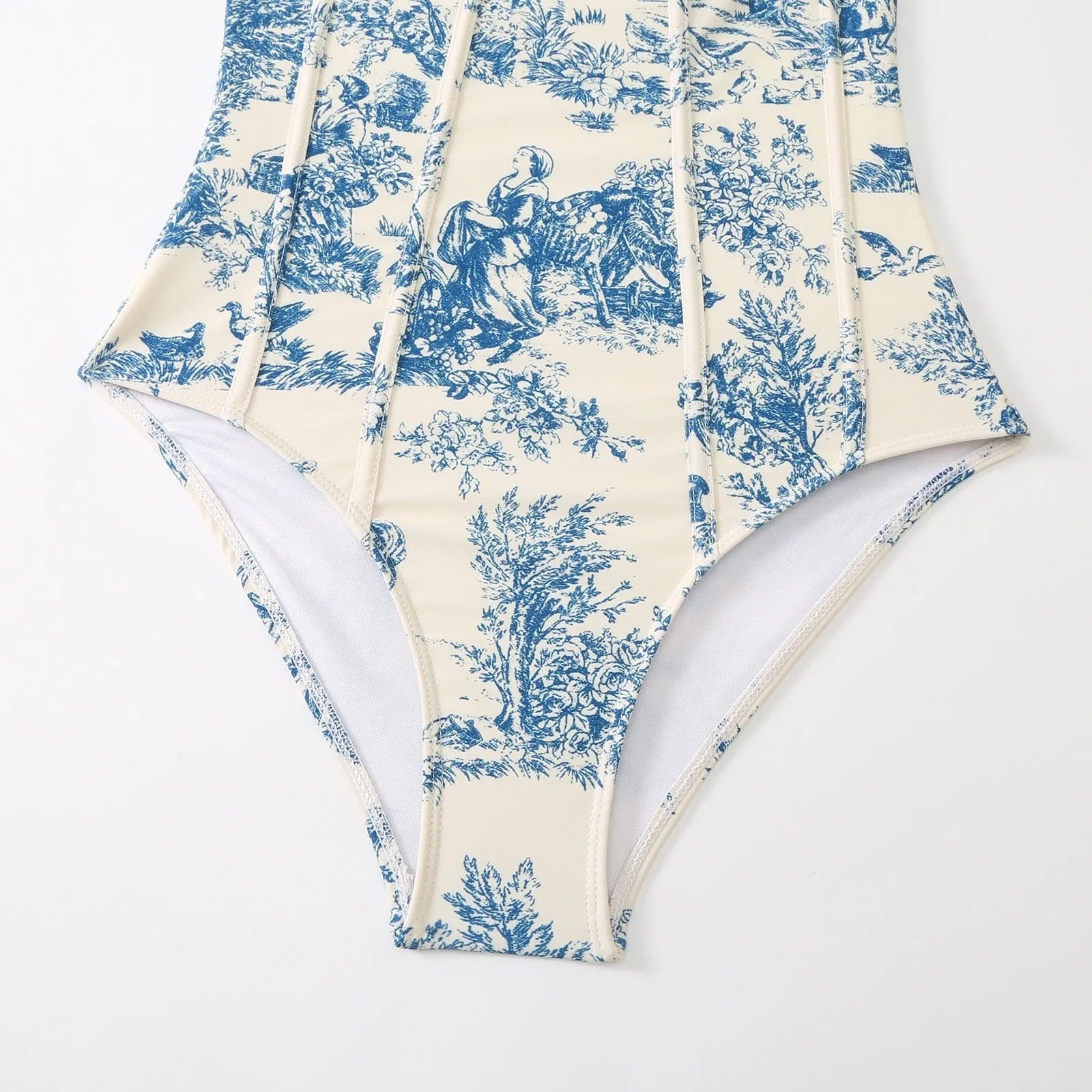 Blue patterned one-piece swimsuit for women on a mannequin, with an optional gauze skirt shown alongside.