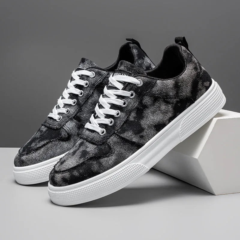 Men's low-top blue canvas sneakers with white platform sole and lace-up front.