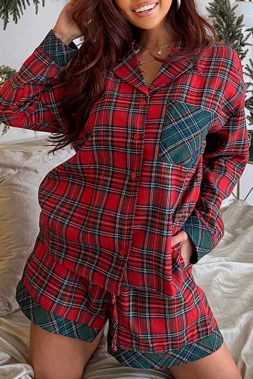 Red and black plaid Christmas pyjama set with contrast fabric patches on the shirt and matching shorts.