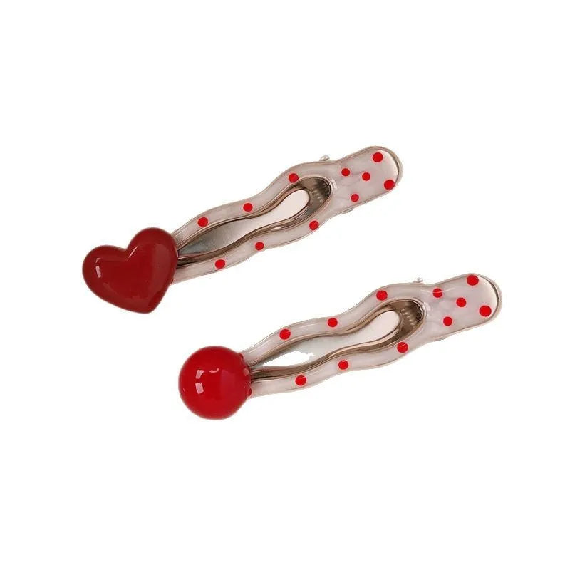 Red heart-shaped hair clip with retro dot patterns and willow leaf clip design
