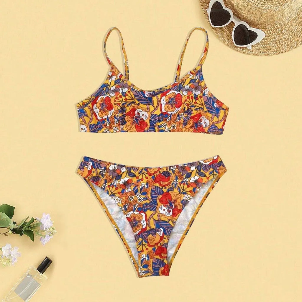Plus size floral print strapped bikini swimsuit top and briefs on a white background.