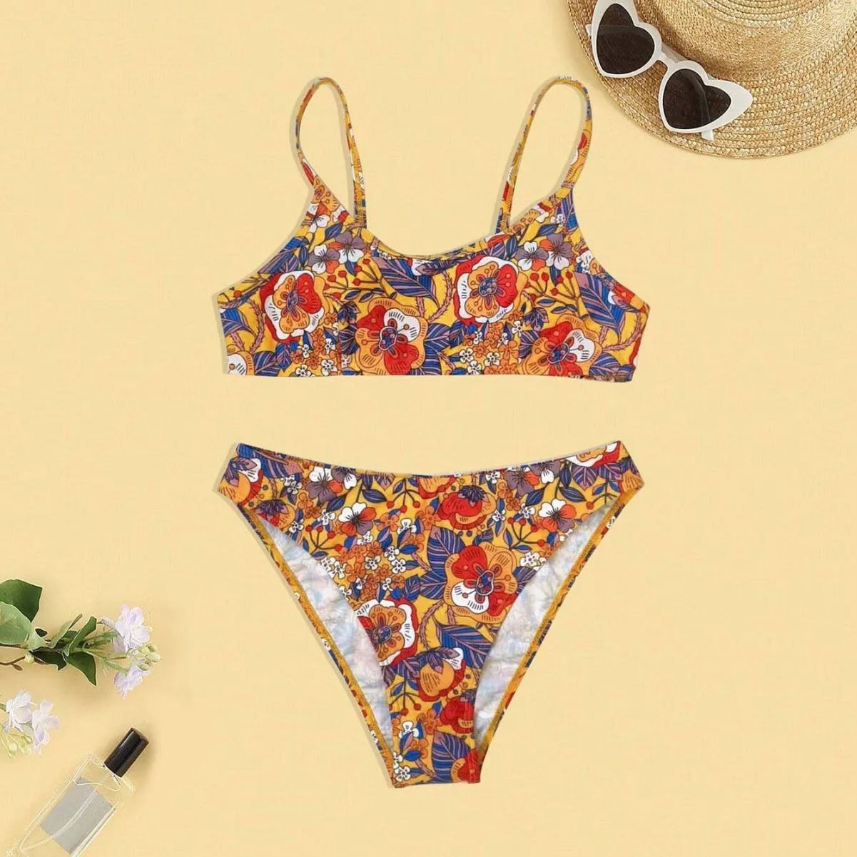 Plus size floral print strapped bikini swimsuit top and briefs on a white background.