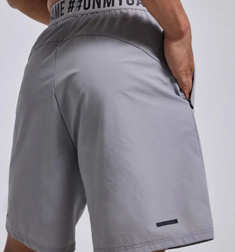 Men's loose black sports shorts with an elastic waistband and printed letter design.