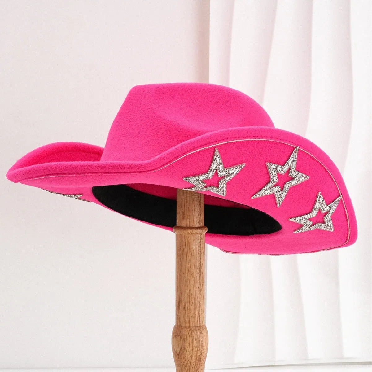 Beige woolen felt western denim top hat with a conical crown and a hexagonal star decoration on the front.