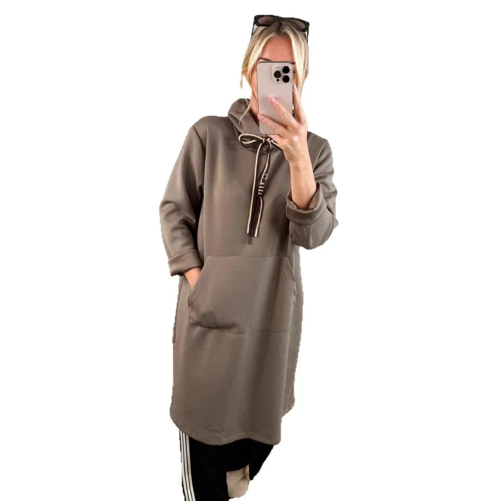 Woman wearing loose oversized knit hooded maxi dress in solid colour with front pockets, pullover style, black colour option
