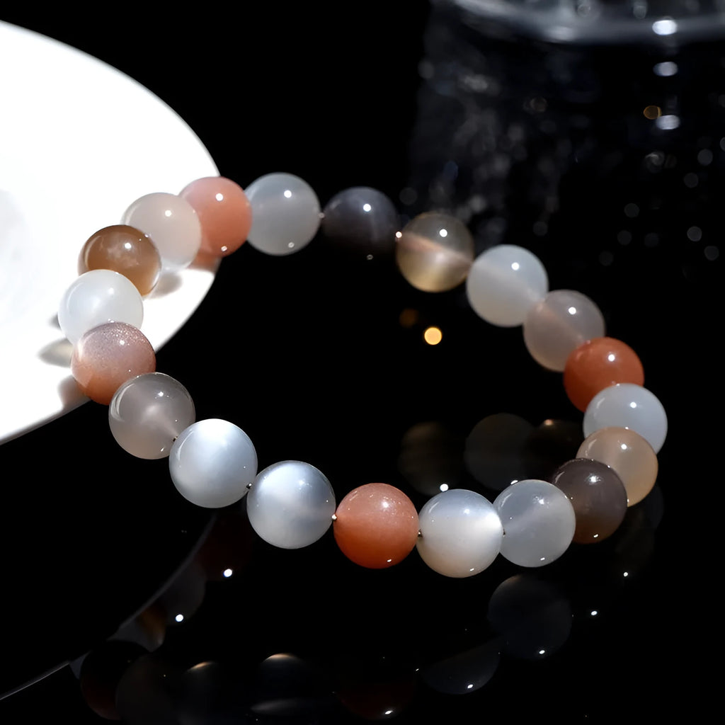 Natural colourful moonlight moonstone bracelet with 8mm single circle beads on a wrist.