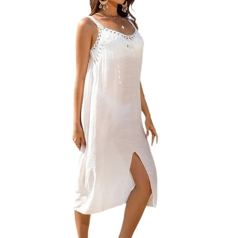 White women's beach dress with crochet weave, adjustable suspenders, and a split bottom hem.