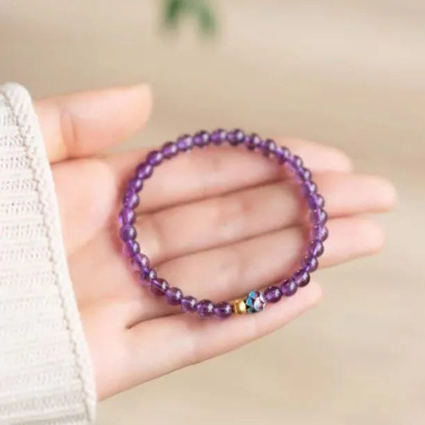 Retro mixed material bracelet with a detailed nine purple lotus design.