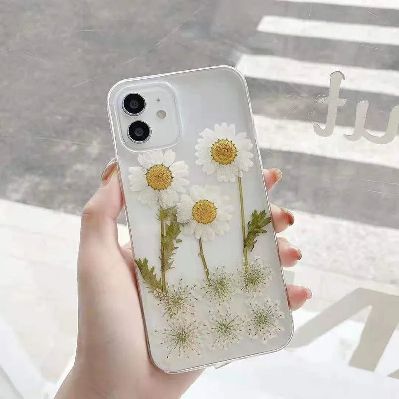 White TPU iPhone case with a raised epoxy daisy floral design on the back.