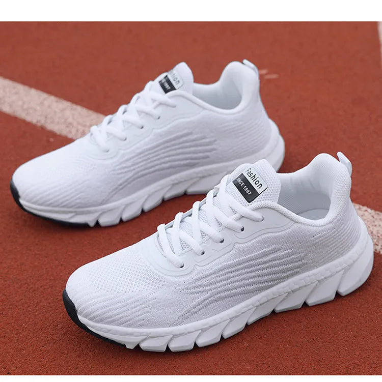 Black and white platform running sneakers with round toe and cross strap details