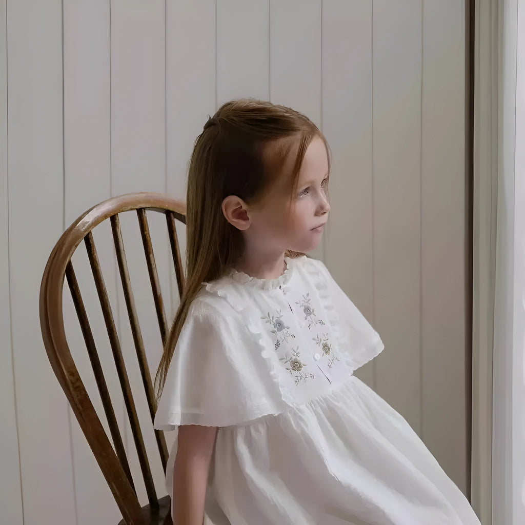 White cotton girls dress with embroidered ruffles, short sleeves, solid colour A-line shape