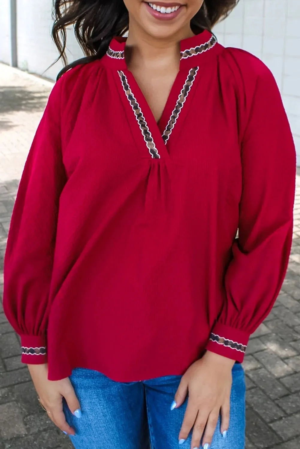 Women's red loose fit polyester pullover shirt with embroidered collar and printed detail