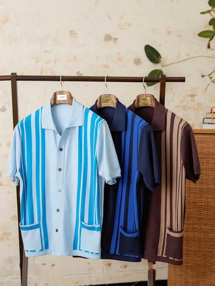 Man wearing a royal blue striped short-sleeved knitted polo cardigan with a lapel collar.
