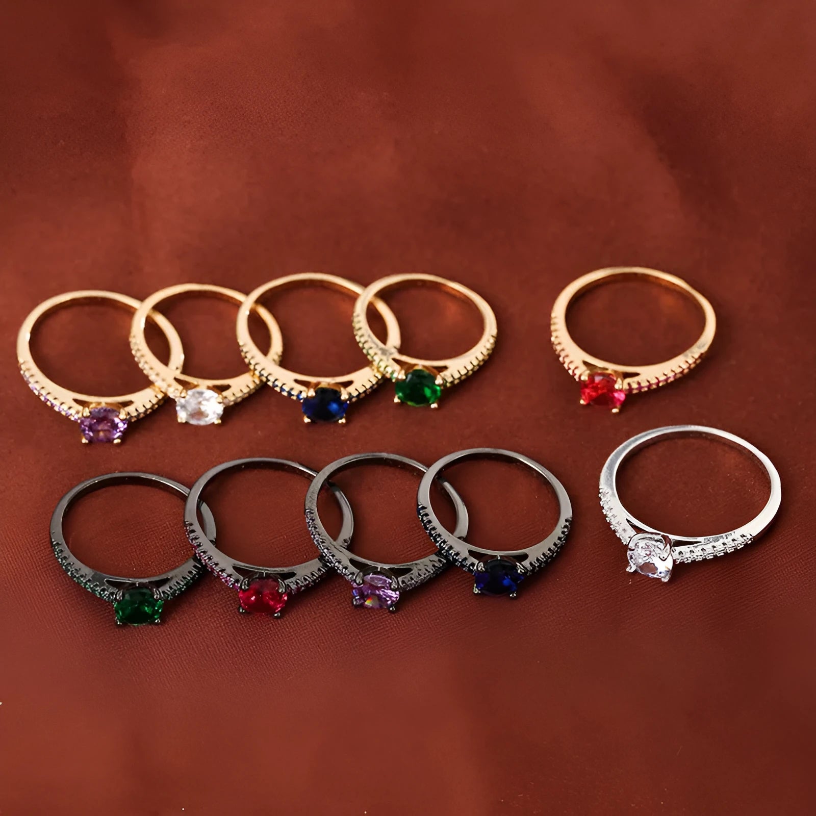 A geometric hexagonal copper ring with a central zircon stone, shown in a gun black and rose red electroplated finish.