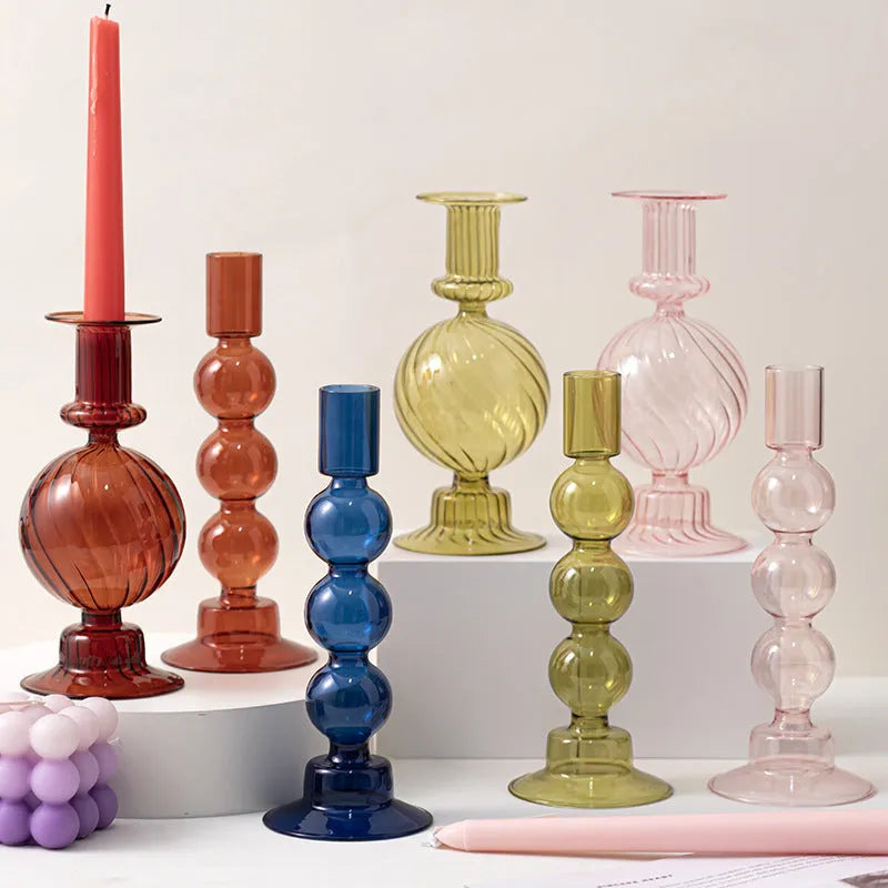 Transparent borosilicate glass candle holder in Three Ball Mott design, available in brown, blue, pink, green