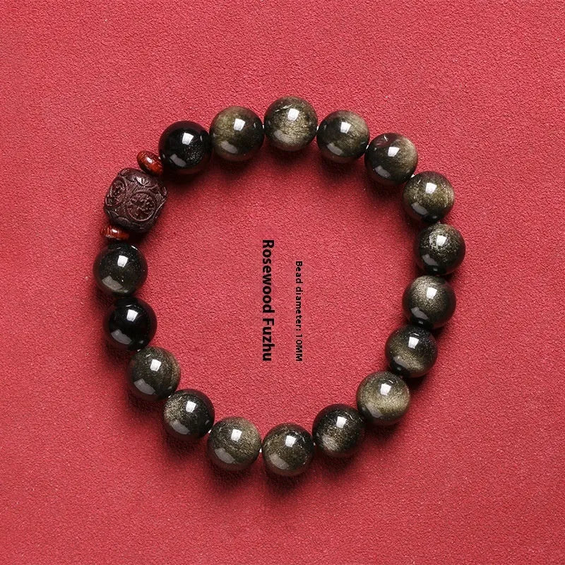 Close-up of a hand-woven Better Luck Beads bracelet with 10mm round Golden Obsidian beads in a retro style.