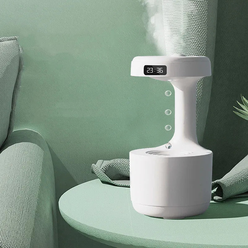 White columnar anti-gravity humidifier on a desk with LED clock display and visible mist.