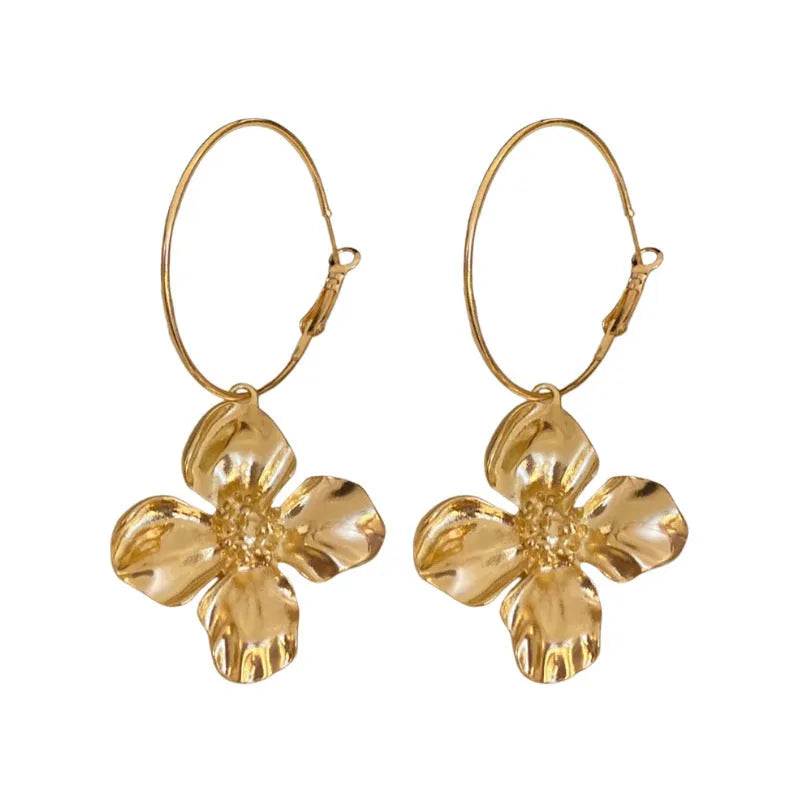 A pair of vintage-style metal earrings with a combined floral and geometric shape in a gold electroplated finish.
