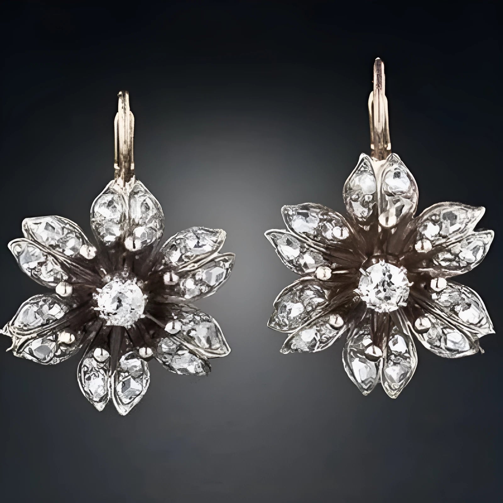 A pair of silver retro-style drop earrings for women on a white background.