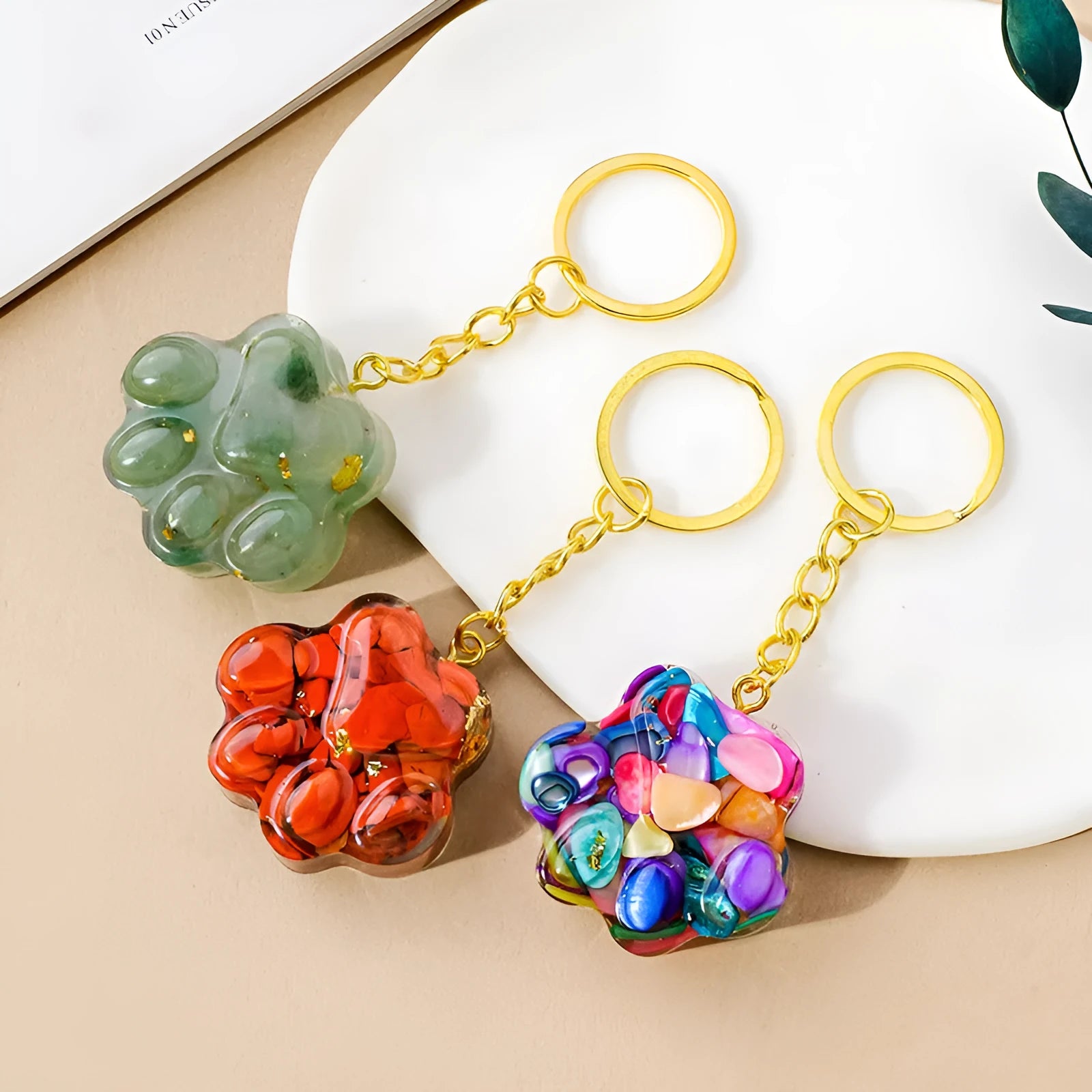 Natural crystal cat's paw keychain pendant on a stainless steel ring, showing detailed carving.