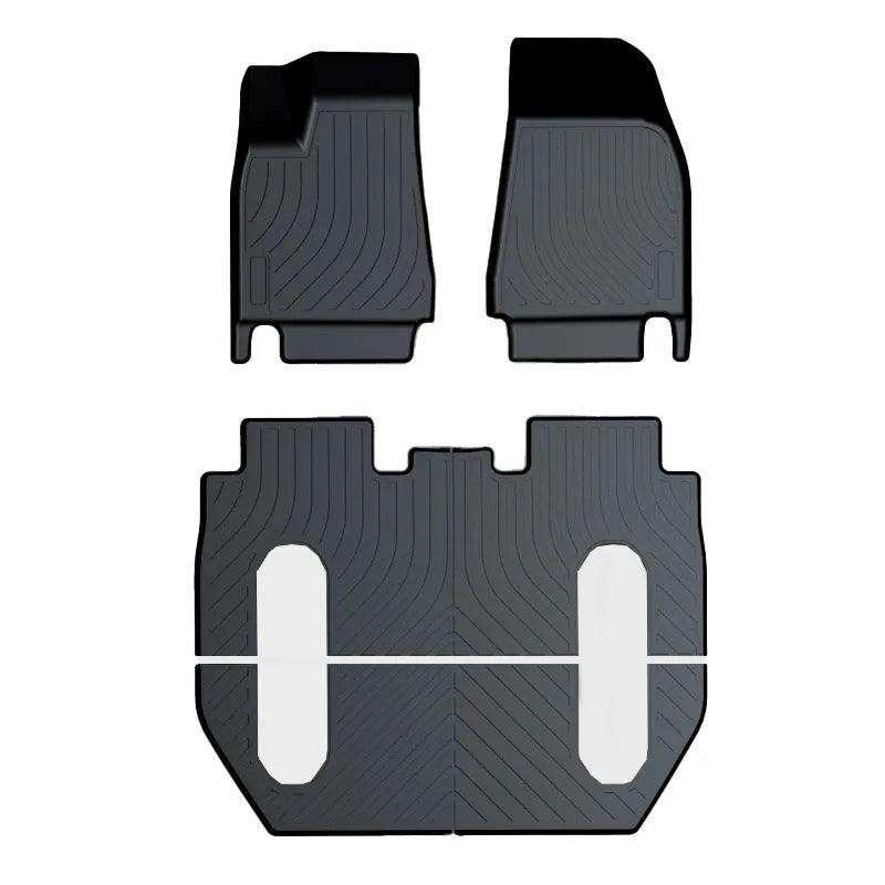 Rubber and TPE floor mat set for a Tesla car interior.