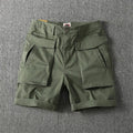 Men's straight-leg cargo shorts in army green with multiple button-closed pockets on thighs and sides.