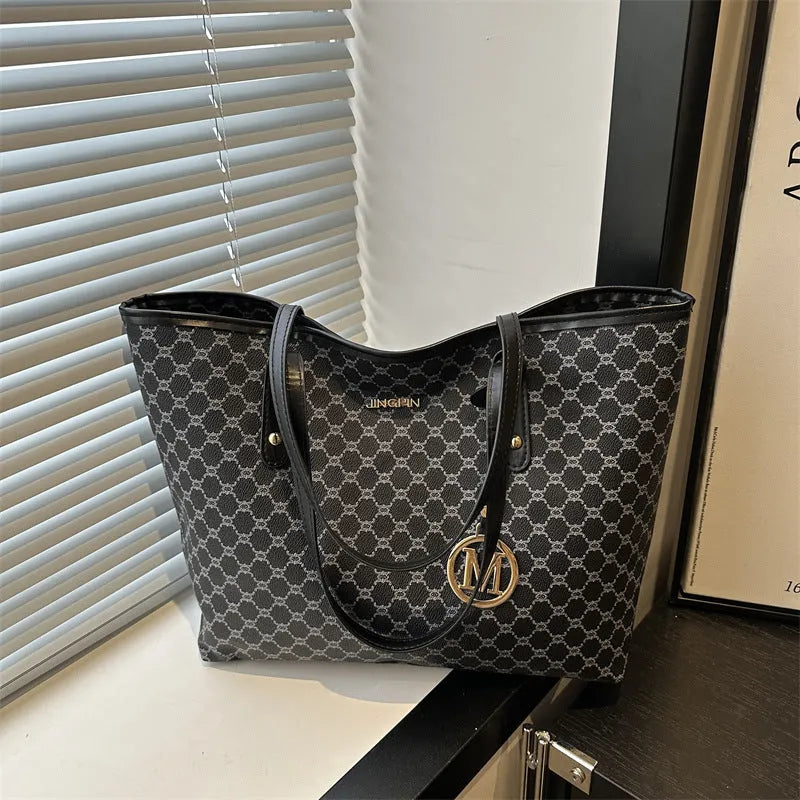 Western style women's shoulder bag in PU leather with contrast stitching, shown in black.