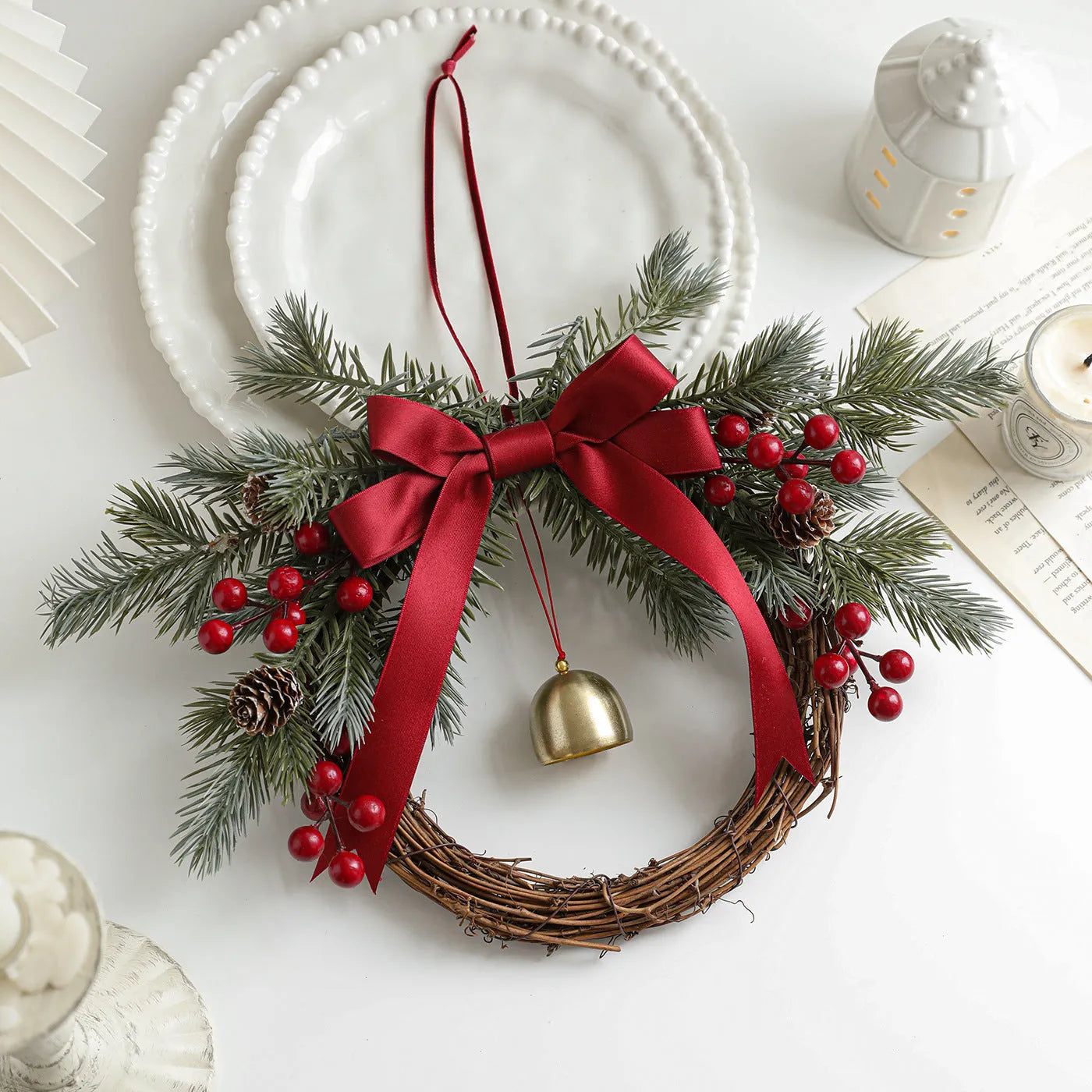 New Christmas rattan plaited garland with bell, bow, and Stranvaesia davidiana berries in light luxury style on a dark background