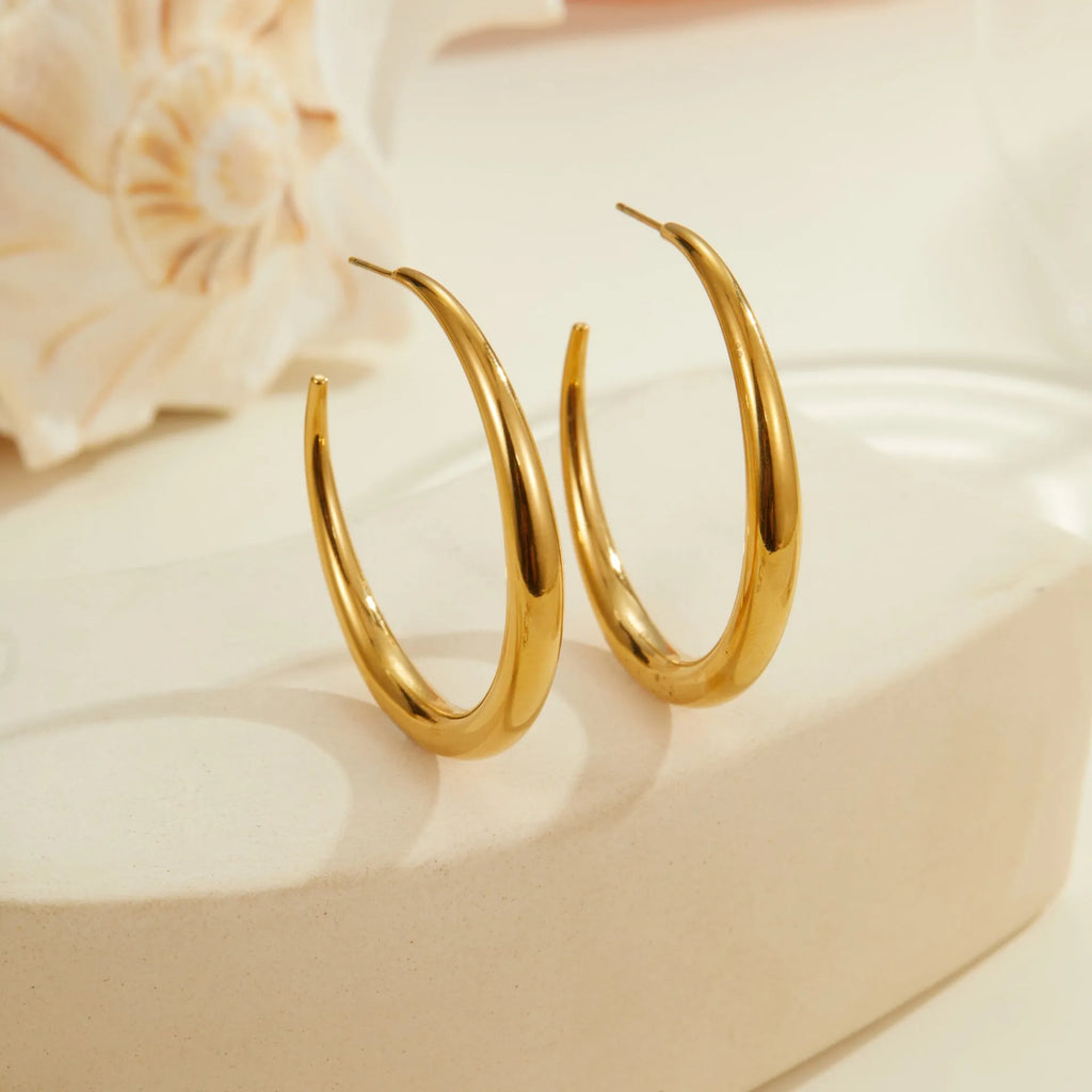 Titanium steel hoop earrings with 18K gold plating in geometric round design