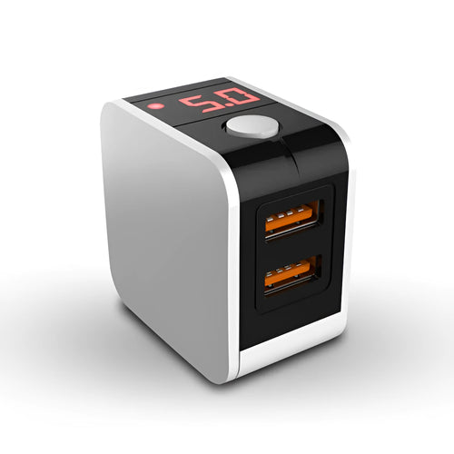 Compact black dual USB travel charger with a digital voltage display showing 5.0V, next to a UK plug.
