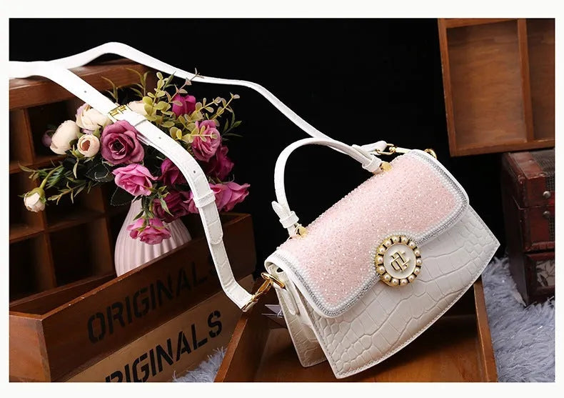 Patent leather diamond portable shoulder bag in black, brown, pink, and red with lock detail and single strap
