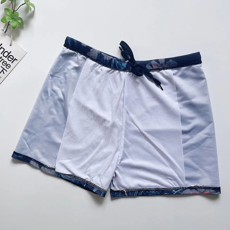 Men's loose fit anti-embarrassment swimming trunks in dark blue background large flower pattern, polyester fabric