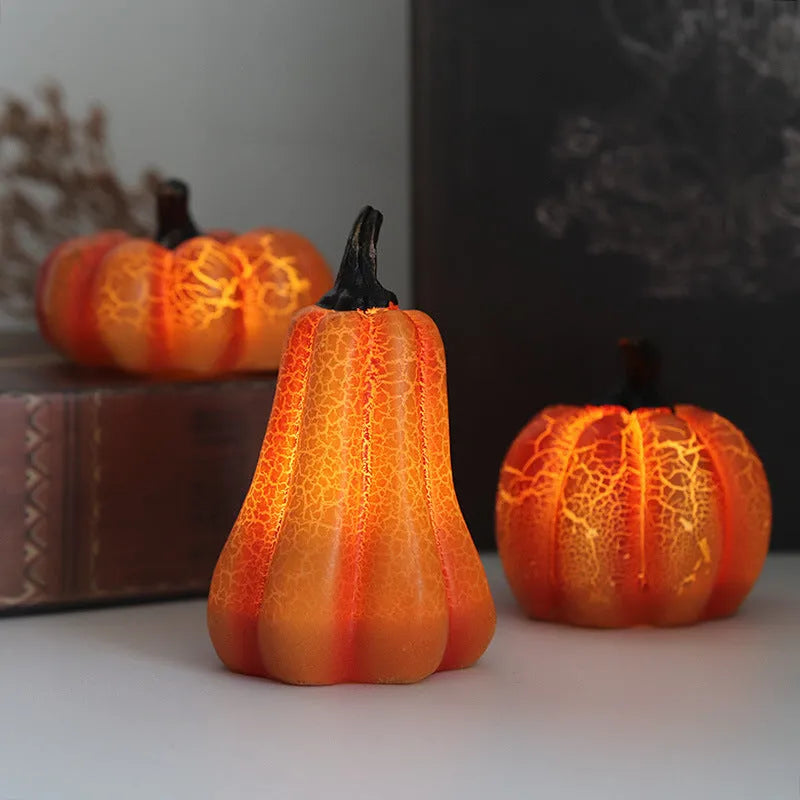 Three LED pumpkin lanterns in different sizes with realistic surface cracks and candle-like glow