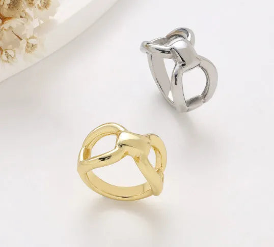 Gold titanium steel women's ring with hollow butterfly and geometric bow design.