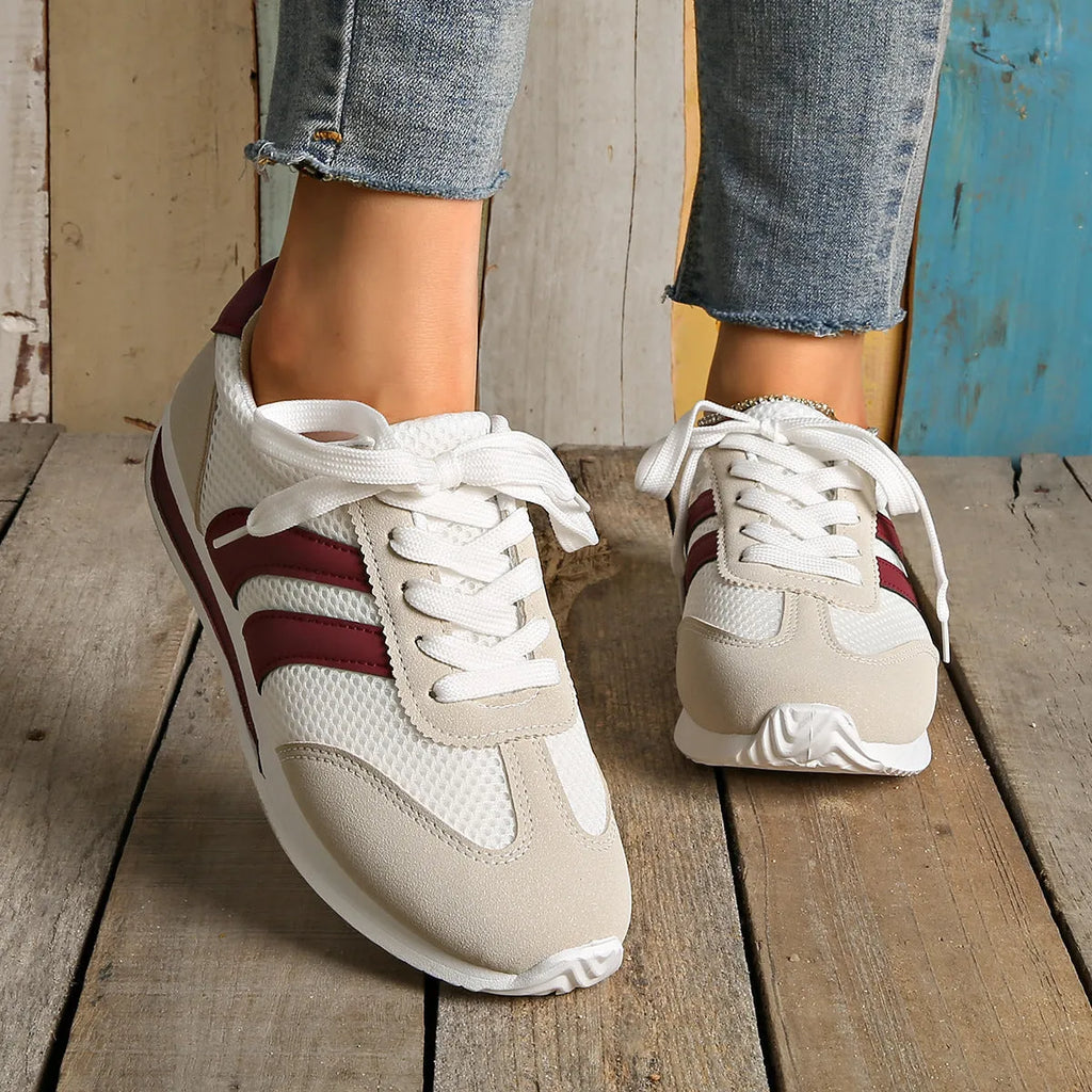 Wine red Cortez retro-style low-top sneaker with a cross-strap over a breathable mesh upper.