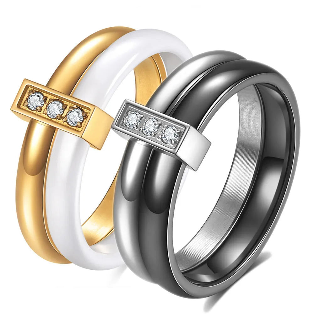 Geometric glossy ceramic women's ring with zirconium inlay, shown in steel black and gold white.