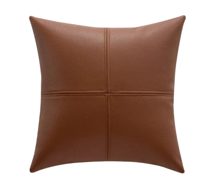 Soft cowhide leather pillow cover in a solid colour, shown in a Nordic-style interior setting.