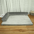 Large grey corduroy dog sofa bed with raised sides on a wooden floor