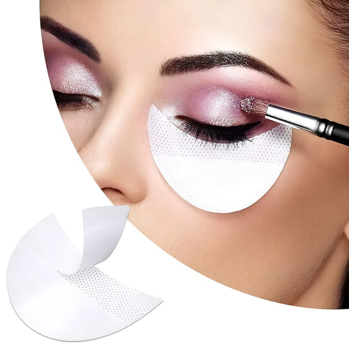 Pack of disposable half-moon shaped eyeshadow shields on a pink background