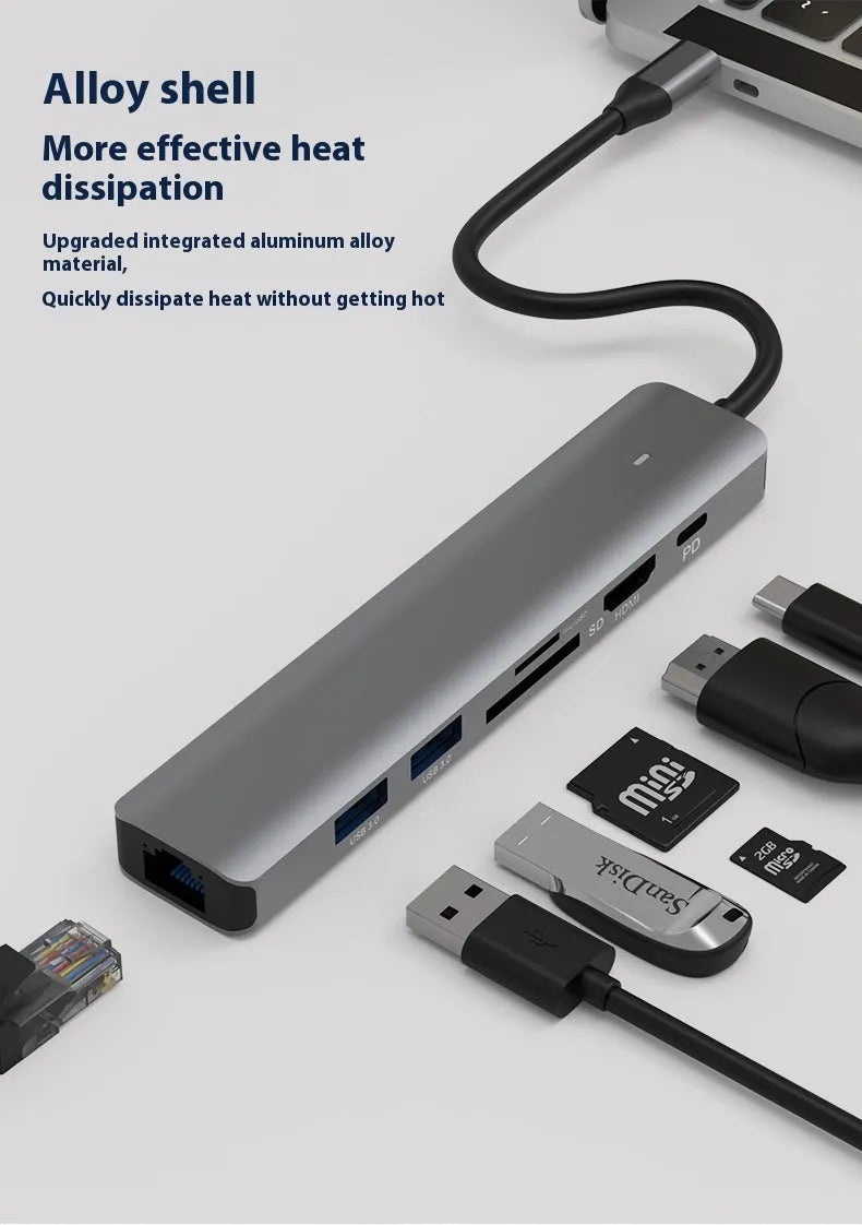 LQT-LH07 7-in-1 USB-C card reader and computer hub on a desk next to a laptop.