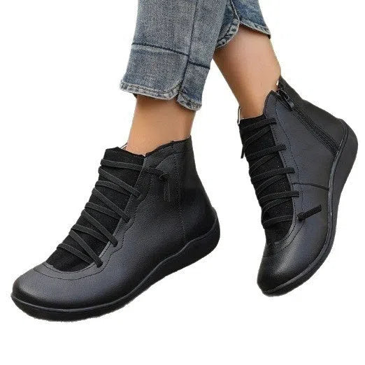 Women's plus size flat side zipper short boots in solid black with round toe and low heel