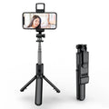 Black selfie stick tripod with wireless Bluetooth remote, universal phone holder, and optional ribbon fill light