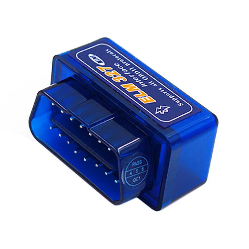 Small black ELM327 Bluetooth OBD2 diagnostic scanner plugged into a car's port.