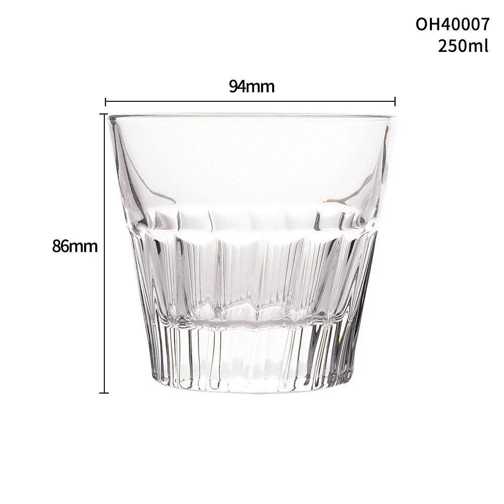 Clear crystal whiskey shot glass with a thick, heavy base on a table.