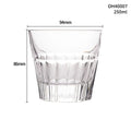 Clear crystal whiskey shot glass with a thick, heavy base on a table.