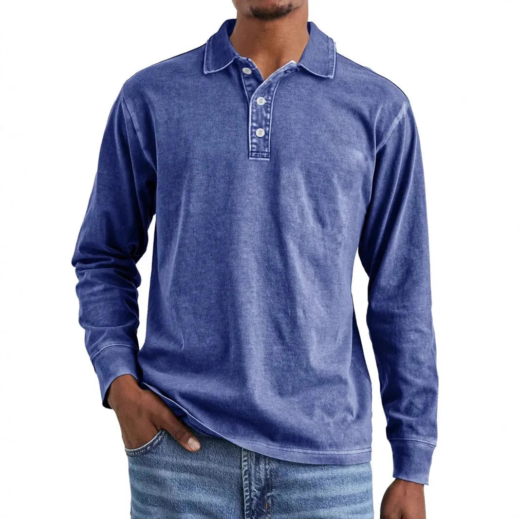 Man wearing a grey washed cotton long sleeve polo shirt with a lapel collar and subtle distressing.