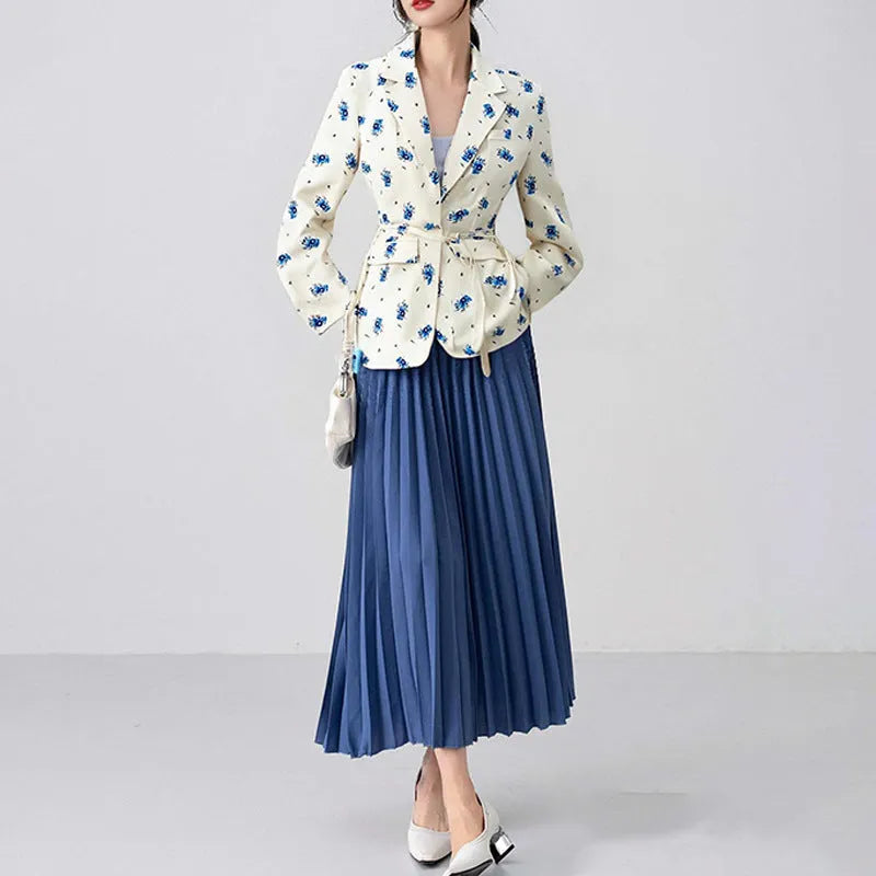 White floral print suit jacket with a lace-up detail at the waist on a hanger.