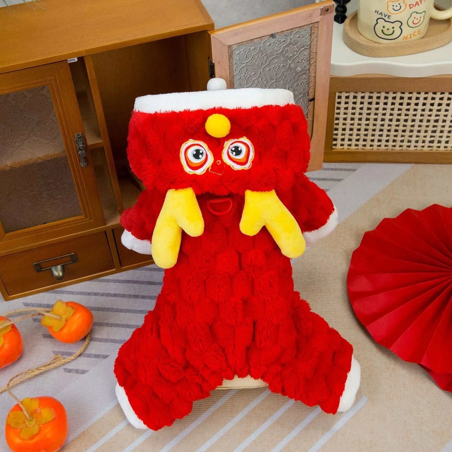 Red double-sided velvet pet jacket with cartoon dragon design shown on dog model