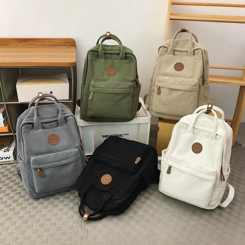 Retro unisex corduroy backpack in solid colour with breathable fabric, side view.